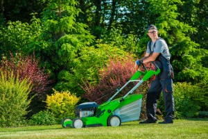 Man mowing lawn, tackling the most common lawncare mistakes in Arizona